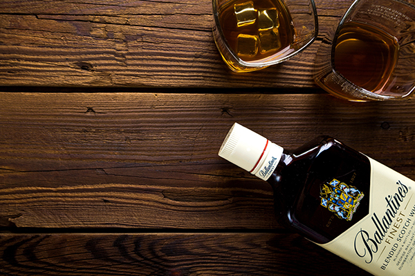 Bottle of whiskey with two glasses on wood table - Webinars Image