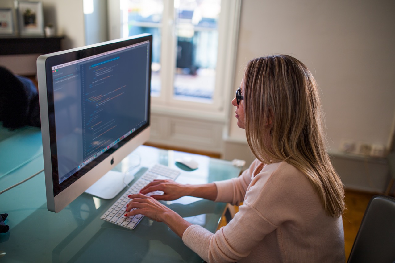 Woman working on an Apple computer