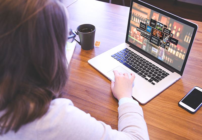 Woman on computer looking at RCS webinar