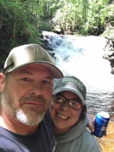 Darlene McQueen and her husband at a waterfall