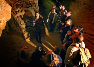 Guests looking up on cave tour