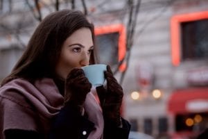 Woman drinking tea outside