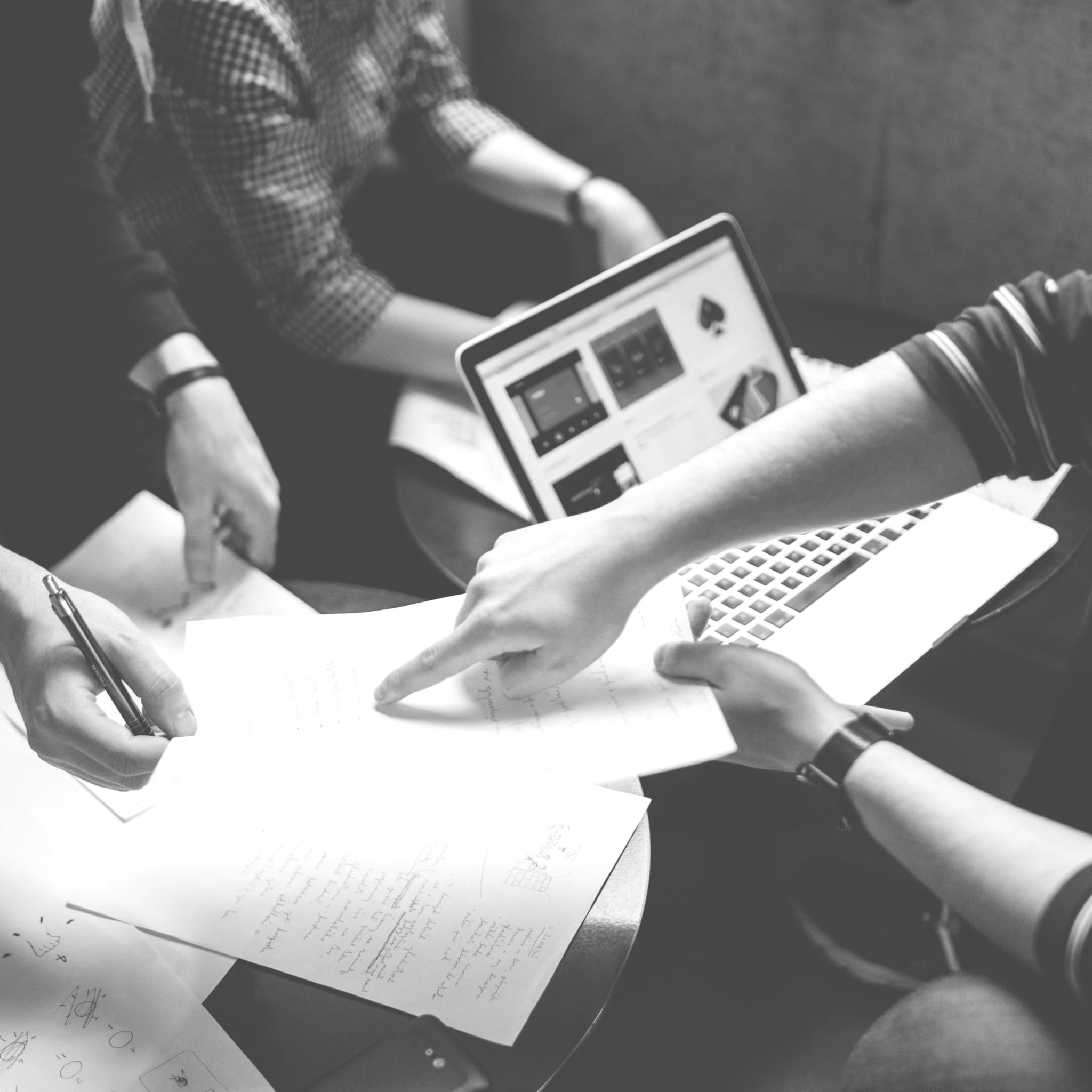 Three people going over paperwork