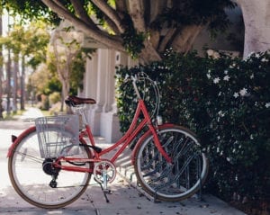 Red bike parked in front of an office