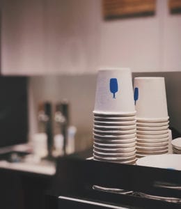Stack of paper cups in a coffee shop