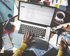 Woman typing on a computer at her desk