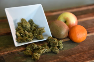 Cannabis nuggets next to fruit