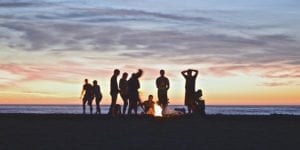 People having a bonfire on a beach