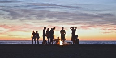 People having a bonfire on a beach