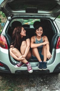 Two women in the back of a car