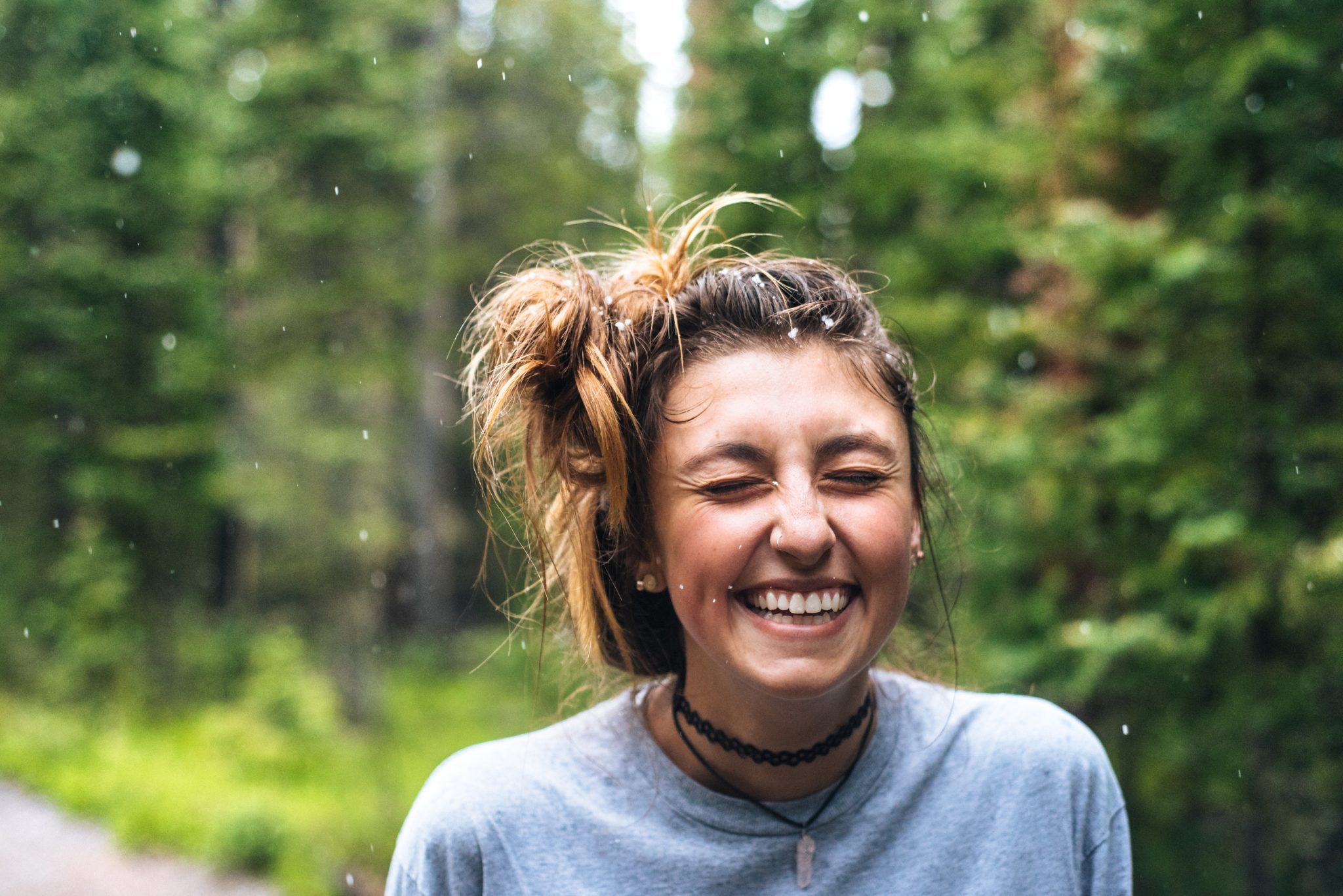 Woman Laughing in a light snow in the woods