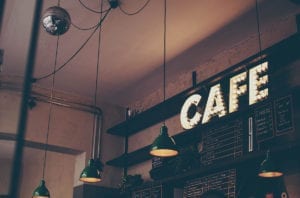 Cafe sign above a menu at a cafe