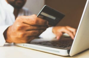 Man with credit card shopping online