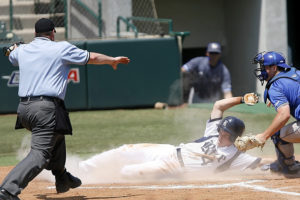 Baseball Ump calling safe as player slides into home