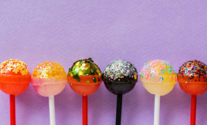 Row of lollipops on purple background