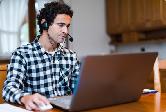 Support Technician sitting at a computer wearing a headset