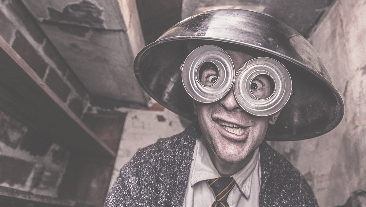 Guy acting goofy with a metal mixing bowl on his head and metal objects around his eyes