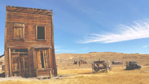 Wild west buildings with wagon and old truck