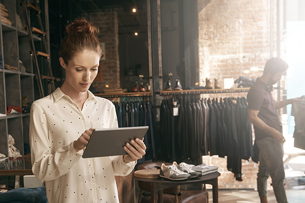 Woman helping customer in a retail apparel store using NCR Counterpoint