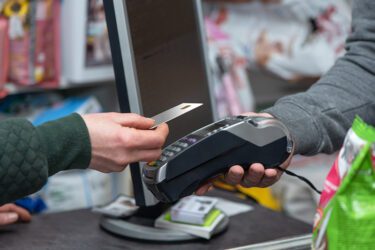 NFC technology, customer do payment with contactless credit card. Credit card reader implements payment execution, in the shop