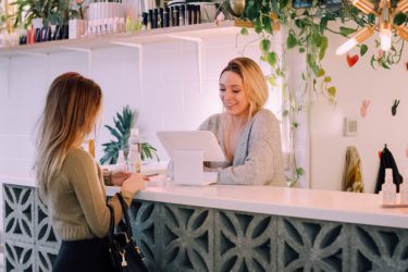 Woman checking out at a boutique store