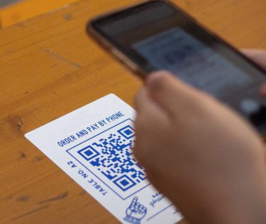 Person scanning a QR code for a menu at a restaruant