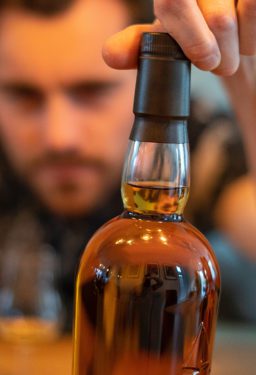 Man staring at liquor bottle