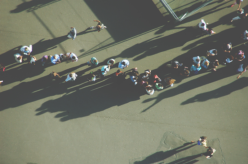 People standing in a line outside a museum