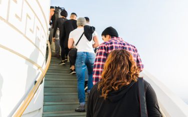 People standing in line on a staircase outside