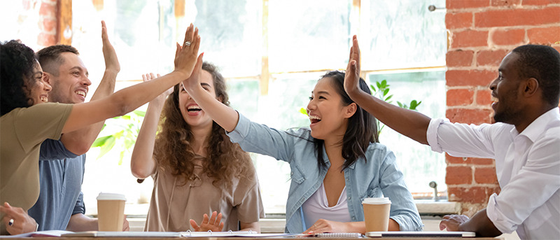 Happy Co-workers going for a high five.