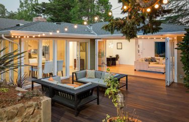 Home with patio furniture / wooden deck at twilight.