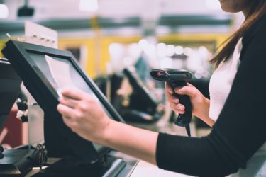 Young woman hands scanning / entering discount / sale on a receipt.