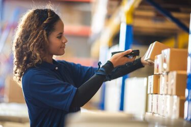 Woman scanning inventory in a warehouse.