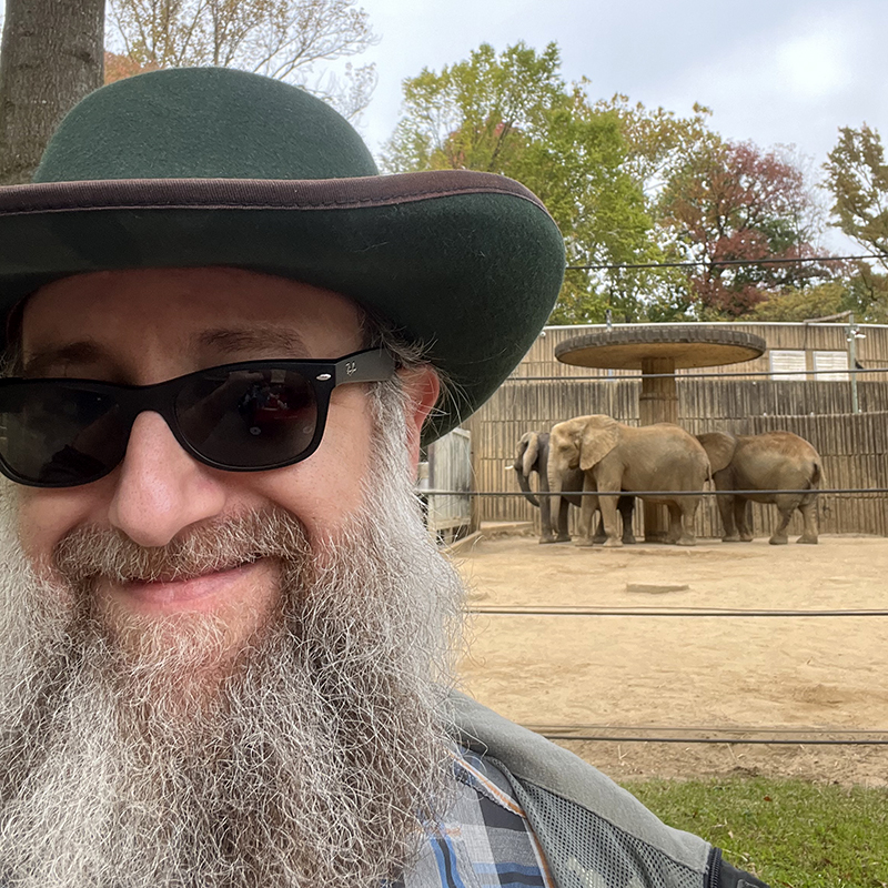 Daniel at the Memphis zoo with some elephants in the background