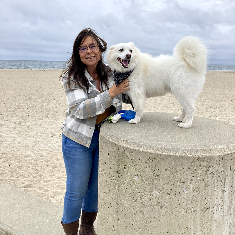 Darlene and her dog Dyson on the beach.