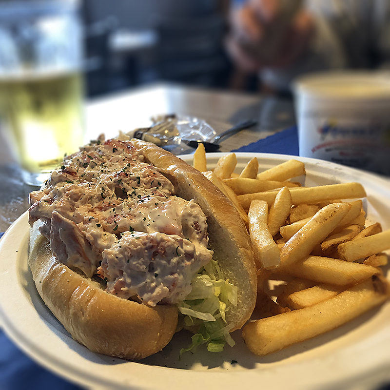 Lobster roll with french fries.