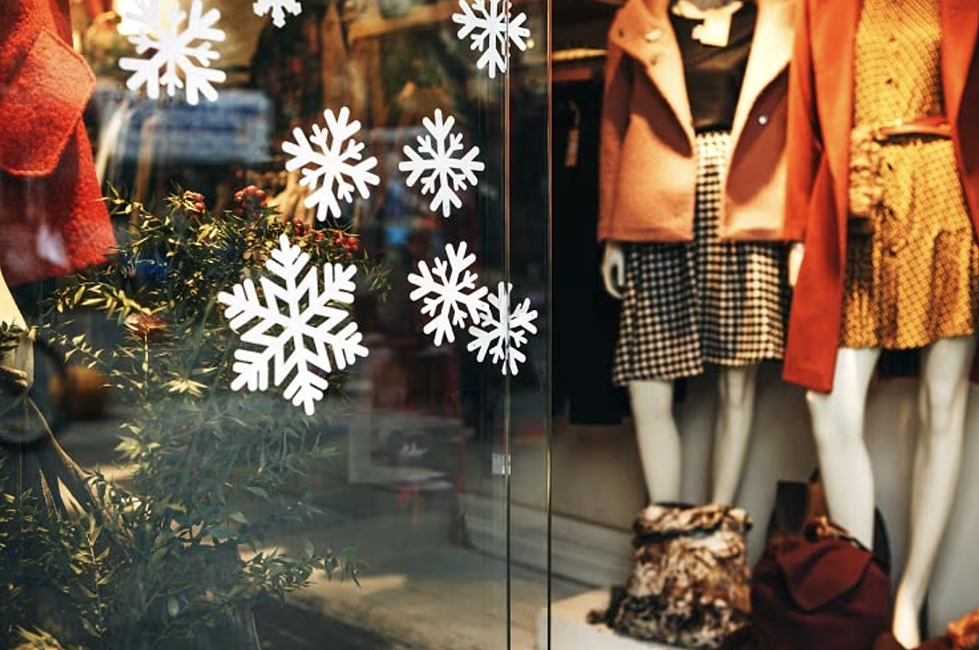Snow flake stencils on the outside of a retail store.