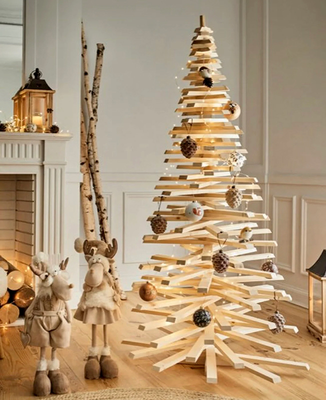 Pieces of wood crafted to look like a Christmas tree with ornaments on it.