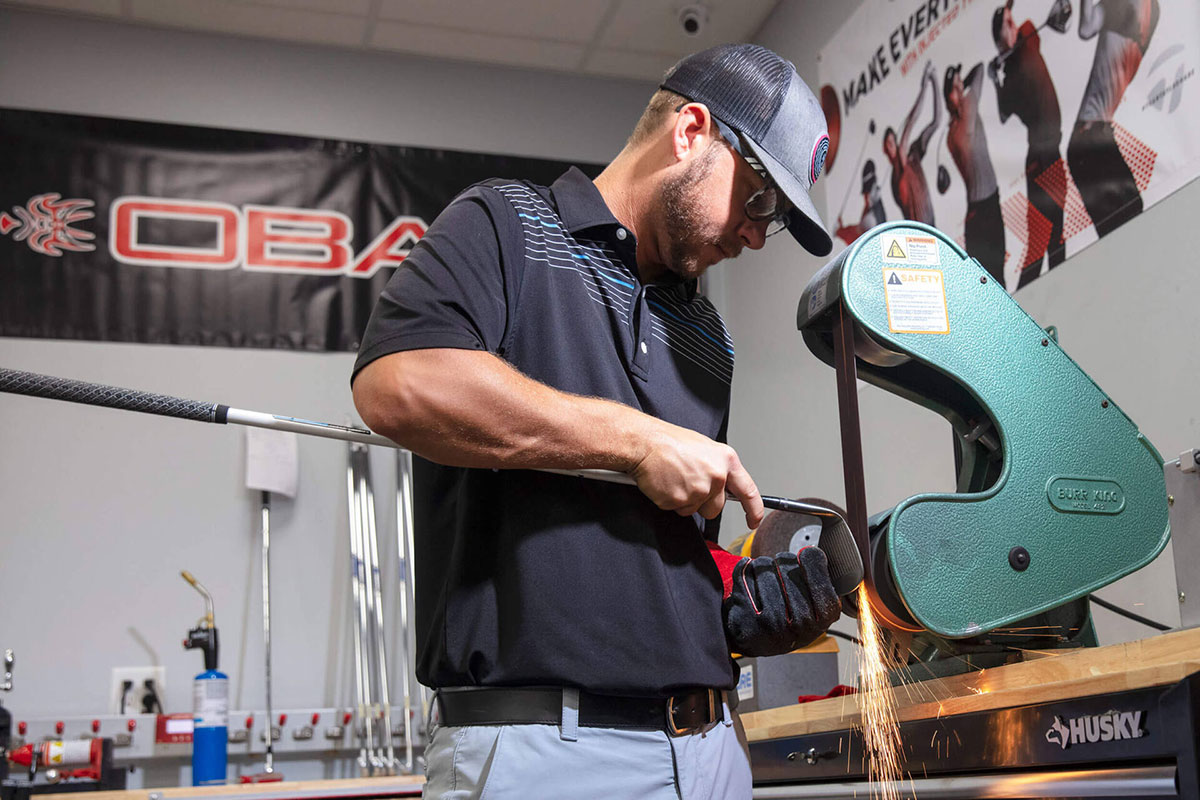 Man working at a golf shop