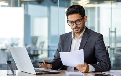 Business man analyzing a report in an office setting.