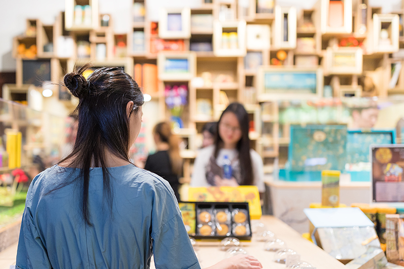 People shopping in a gift shop at a museum.