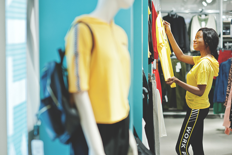 Woman looking at workout clothes in a sporting goods store.