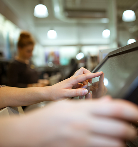 Person typing on a touchscreen point of sale register.