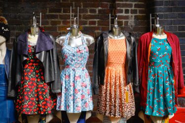 Women dresses on mannequins on display in a thrift store.