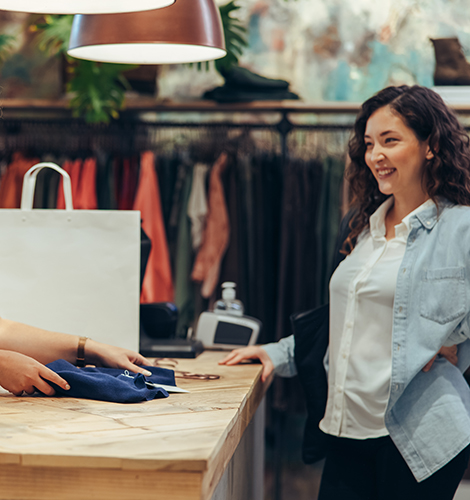 Woman standing at the checkout of a thrift shop.