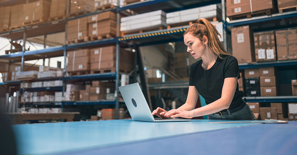 Women in a warehouse using a computer