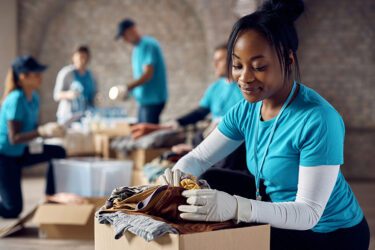 Volunteers packing clothes in donation boxes at a thrift store